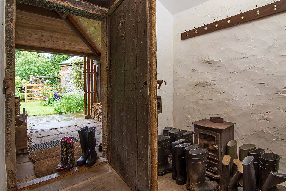 An old open door with wellingtons in the doorway