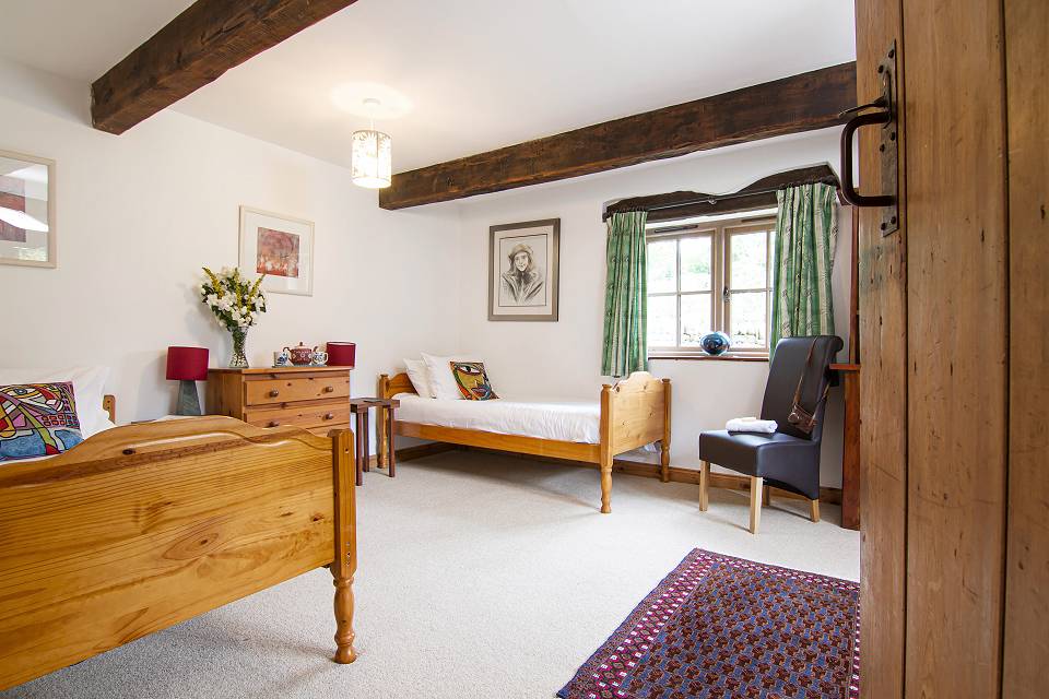 Downstairs bedroom with exposed oak beams