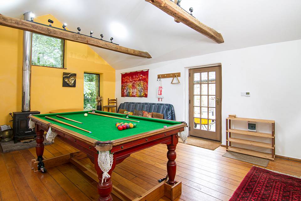 The studio, with pool table, woodburner and exposed oak beams