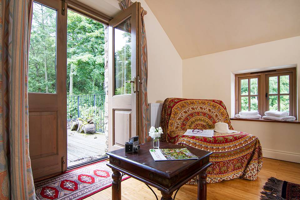 A close up of the corner of the music room with patio doors open to the balcony