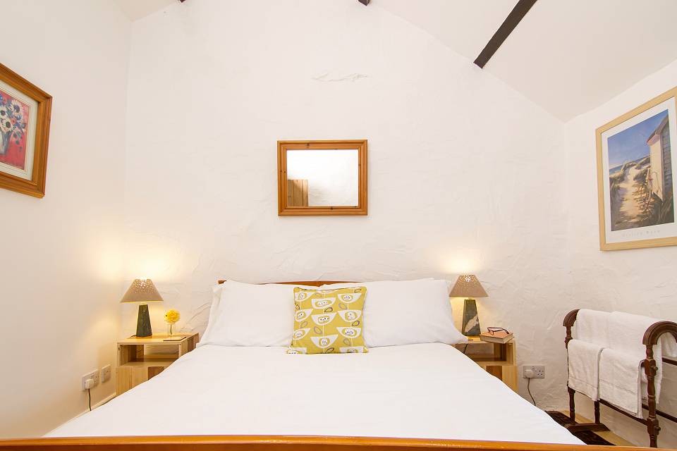 Bedroom with bed and cushions